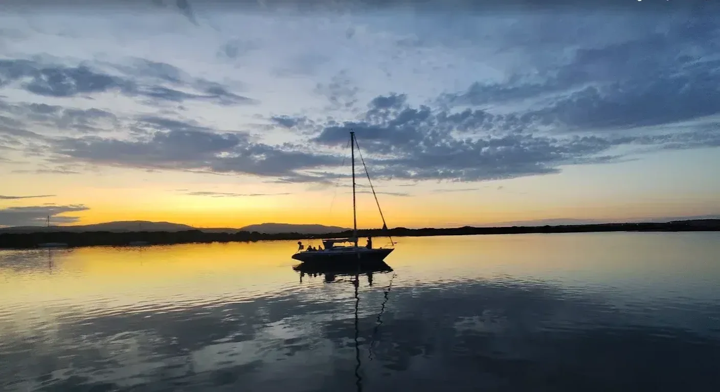 Marriage proposal on board a private sailboat at sunset off the coast of Barcelona